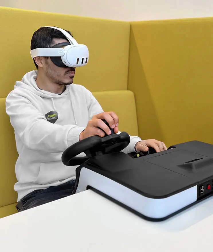 Trainee using the Desktop Sit-Down simulator with a VR headset