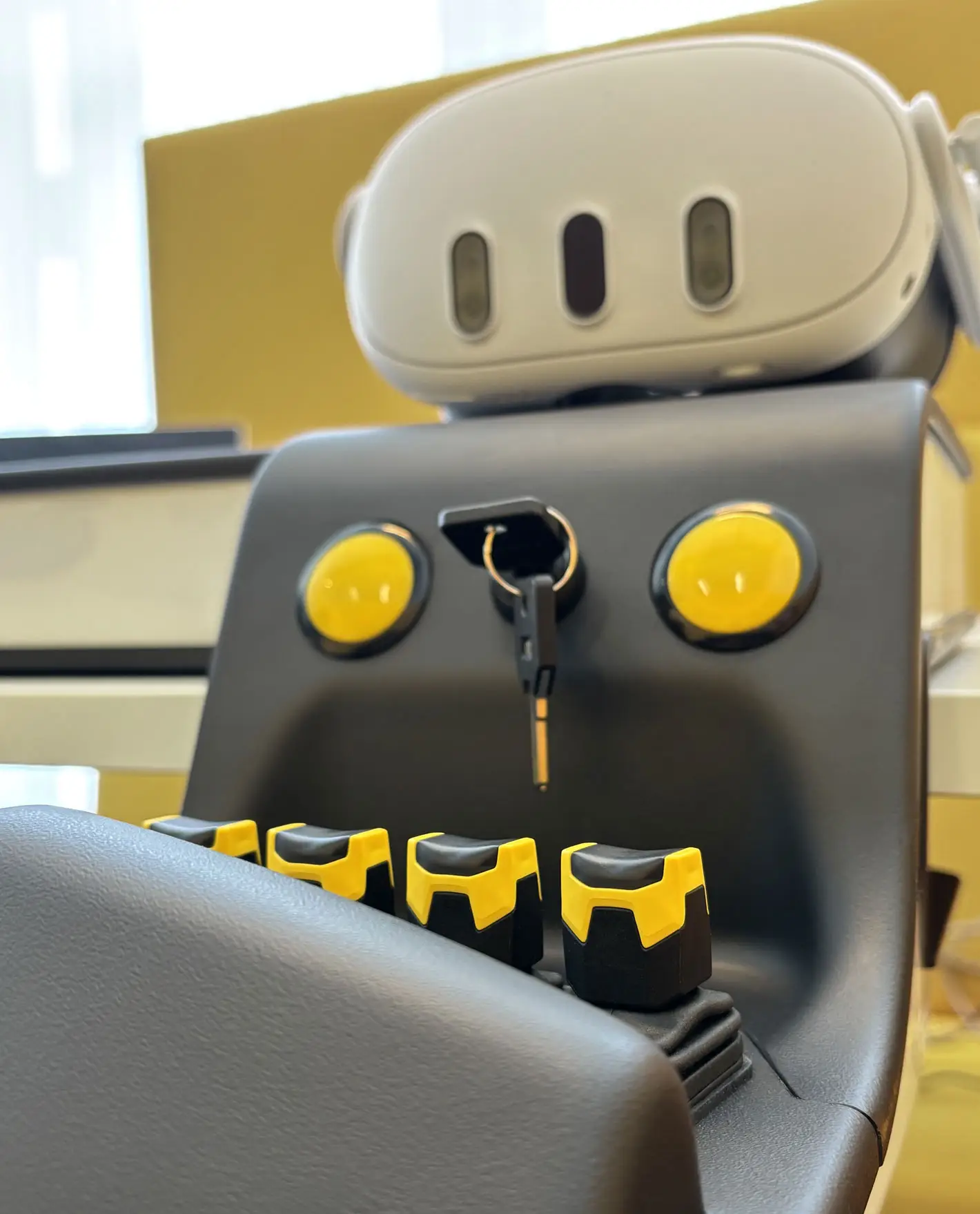 Close-up of the simulator armrest controls and headset
