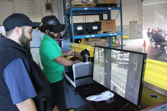 Instructor guiding a student on the simulator